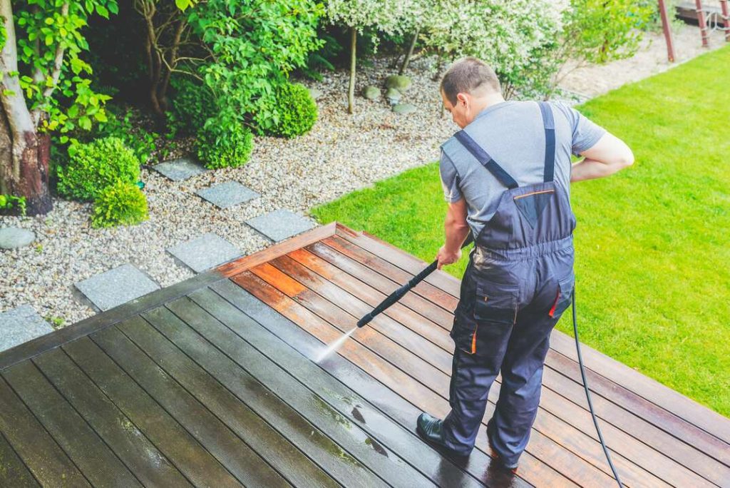 Man powerwashing outdoor floors